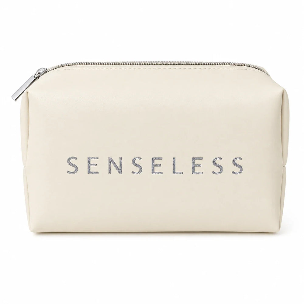 Senseless cosmetics bag in cream with a silver zip and an embossed SENSELESS wordmark