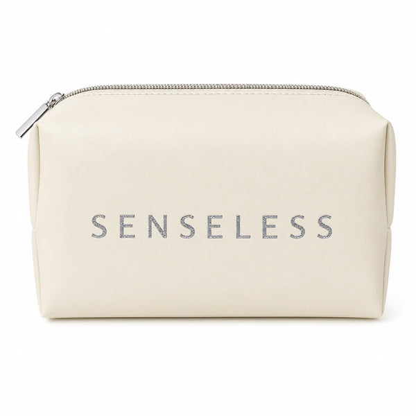 Senseless cosmetics bag in cream with a silver zip and an embossed SENSELESS wordmark